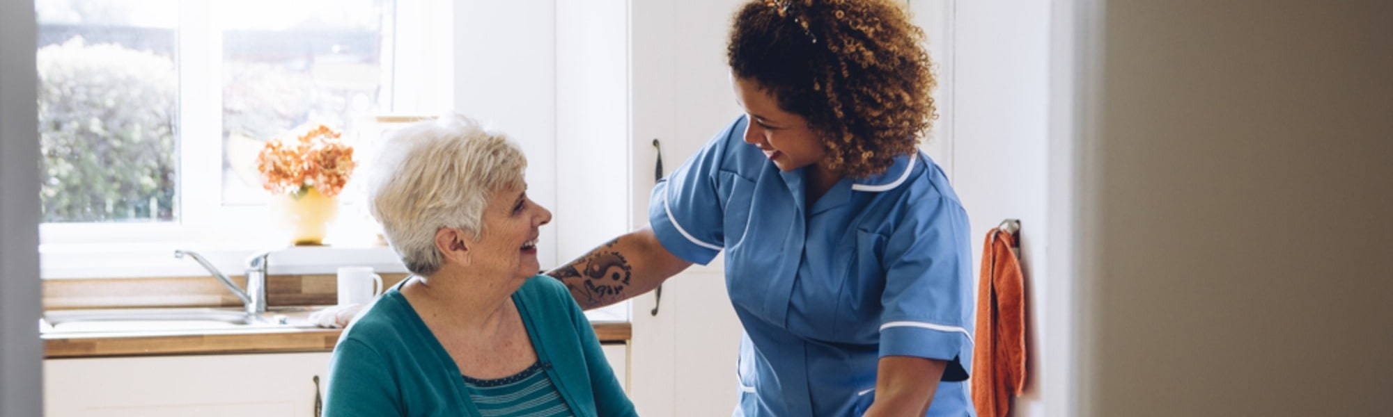 home care nurse and elderly patient smiling